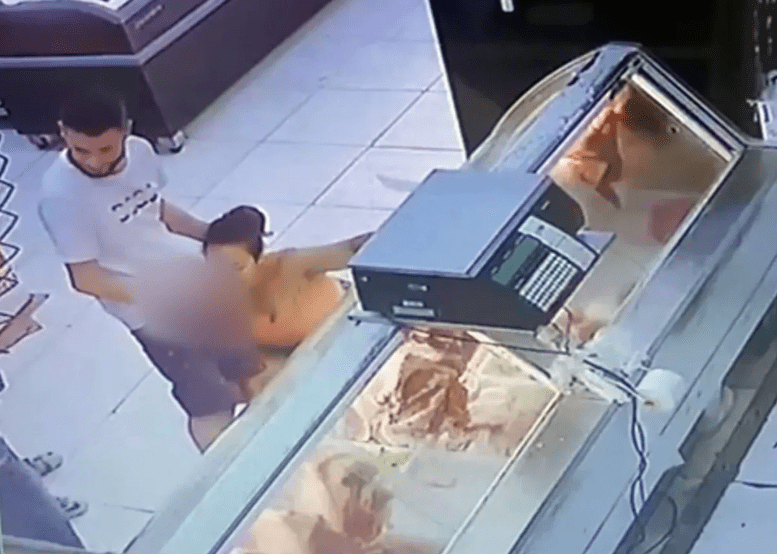 Buyers watch as wife gives husband head in a meat section of a supermarket (Video)