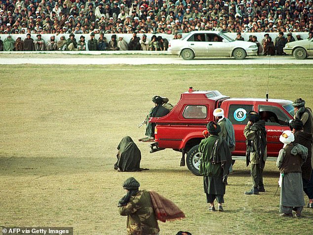 Moment Taliban execute two murderers in front of thousands of spectators at football stadium