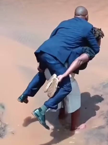 Moment Woman Carries Her Husband On Her Back While Crossing Muddy Road (Photos)