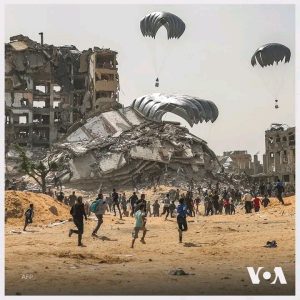 Photos As Gazans Rush To Get Humanitarian Aid Packages Dropped By UAE Air Force